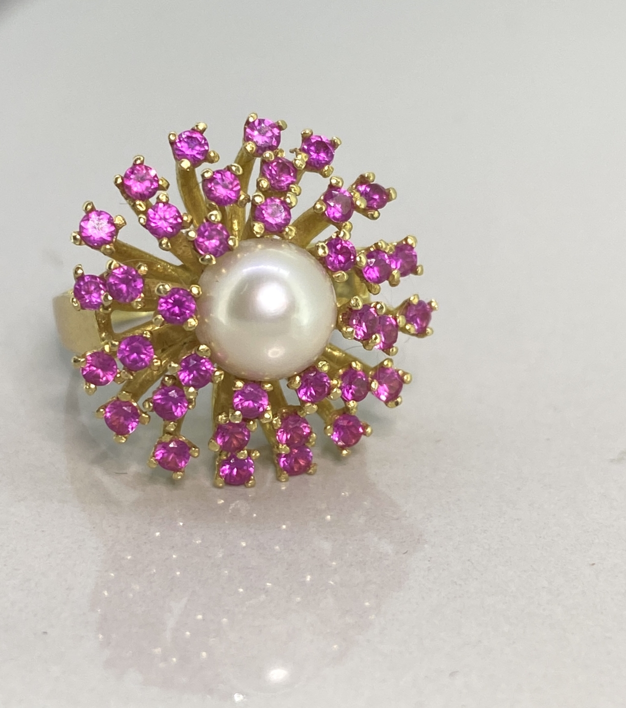 Ruby and Pearl Fancy Cluster Dress Ring in 18 carat Gold. Beautiful bright sparkling rubys with a central cultured pearl.