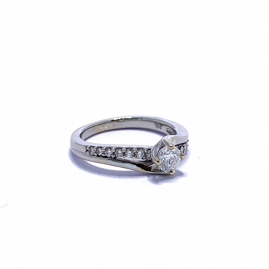 Diamond Solitaire Twist Ring. half a carat of diamond total. Beautiful bright brilliant cut diamond with a band of small diamonds running diagonally behind the main band.