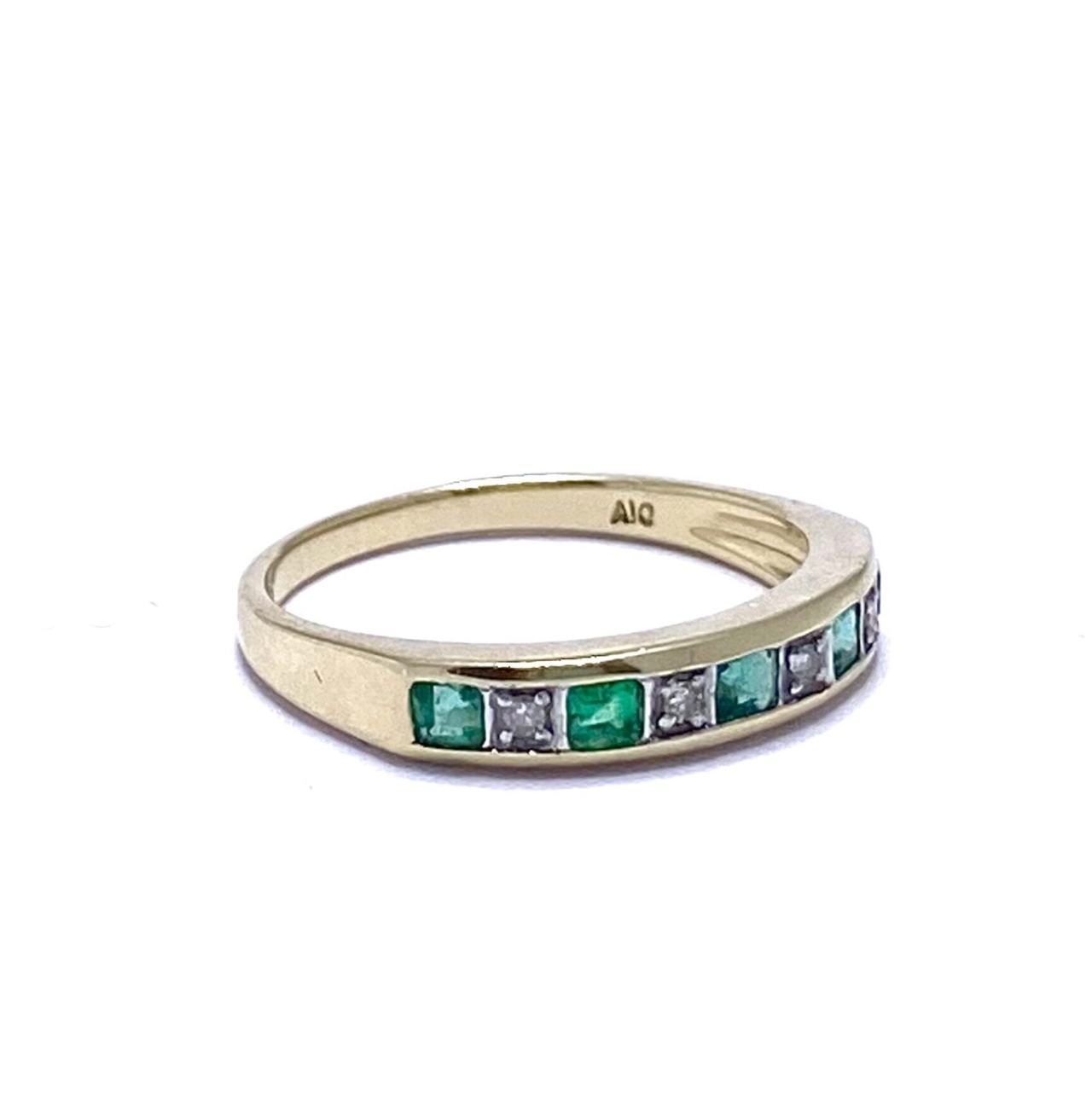 This Antique Emerald Stacking Ring is 9ct and tapers slightly from front to back. The face is rectangular with five alternating flush set glowing Emeralds and four micro Diamonds.