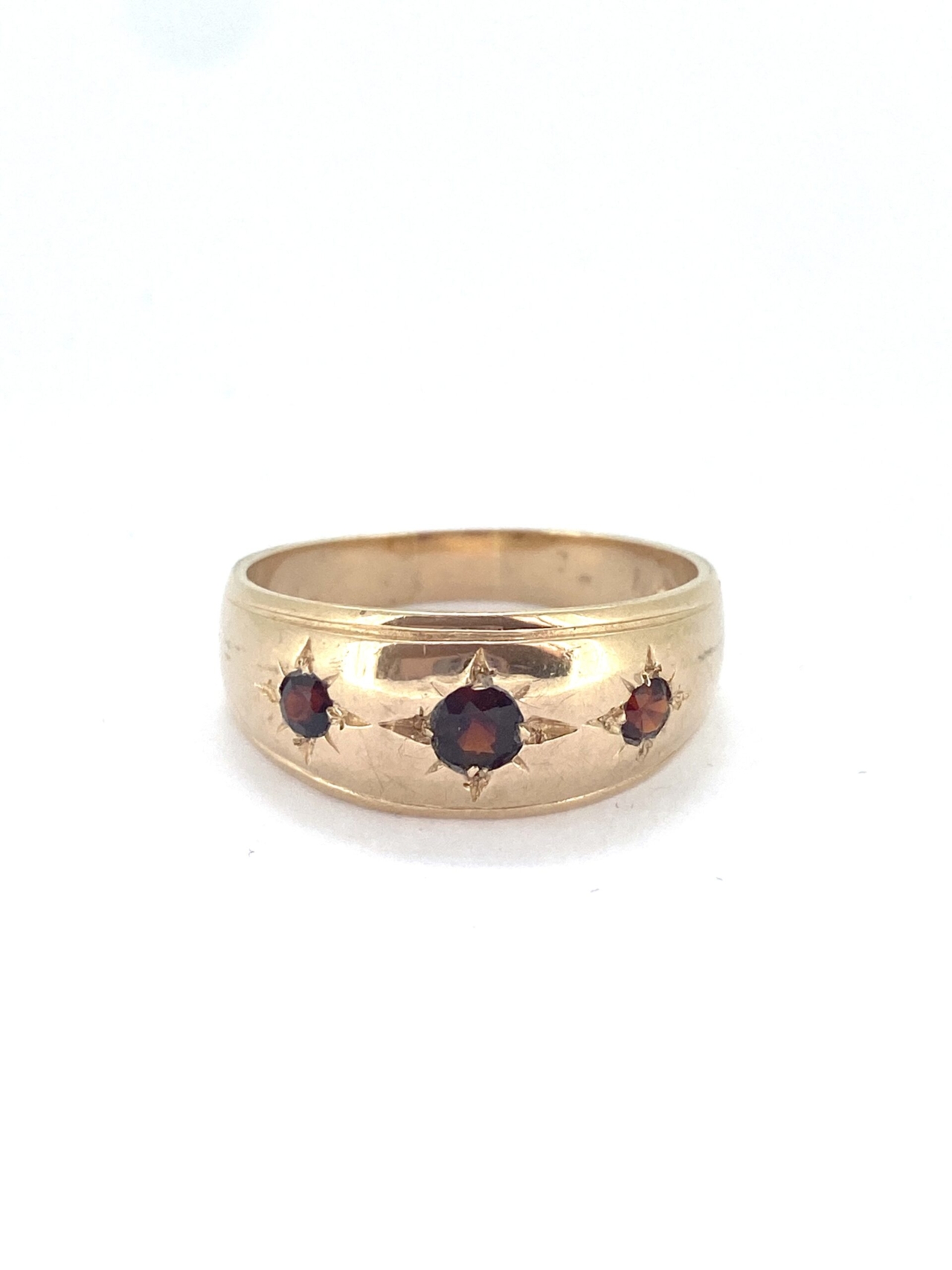 Gypsy Garnet Gold Ring in 9ct gold. The gorgeous buttery gold ring has 3 deep red garnets set in gypsy style setting. The ring is large size X an a half. It can be resized within 2-4 sizes only. It is clearly hallmarked.