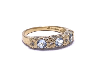 9ct Gold Three stone crystal blue Aquamarine, flush set with four star set diamonds.