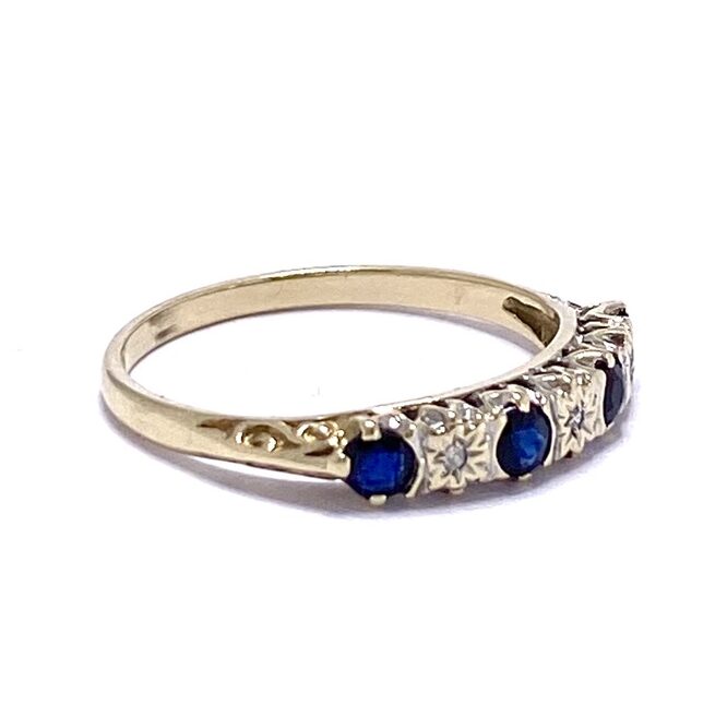 Sapphire and star set Diamond Half Eternity Ring in a rub over setting. The shank is 9ct gold with intricate shoulder scrolling detail
