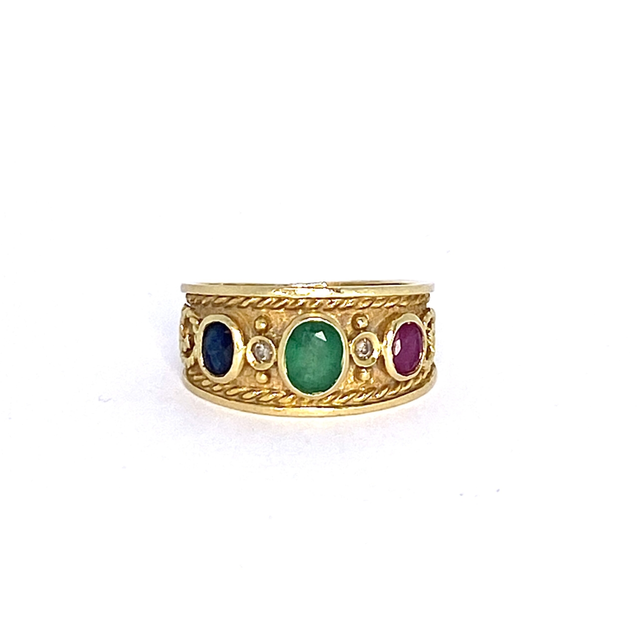 Vintage 3 Multi-stone Ring. The 18ct yellow gold band is set with a central Emerald cushioned between two diamonds, a Ruby and Sapphire.