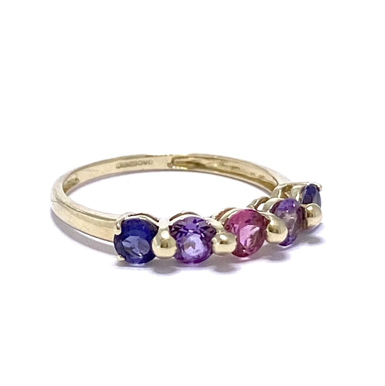 5 Stone Amethyst 9ct half ring. The Amethysts vary in colour from light pink in the centre, to purple and ocean blue. The three central stones are held in place by 2 large ball prongs and the two end stones are held in place with 2 smaller prongs.