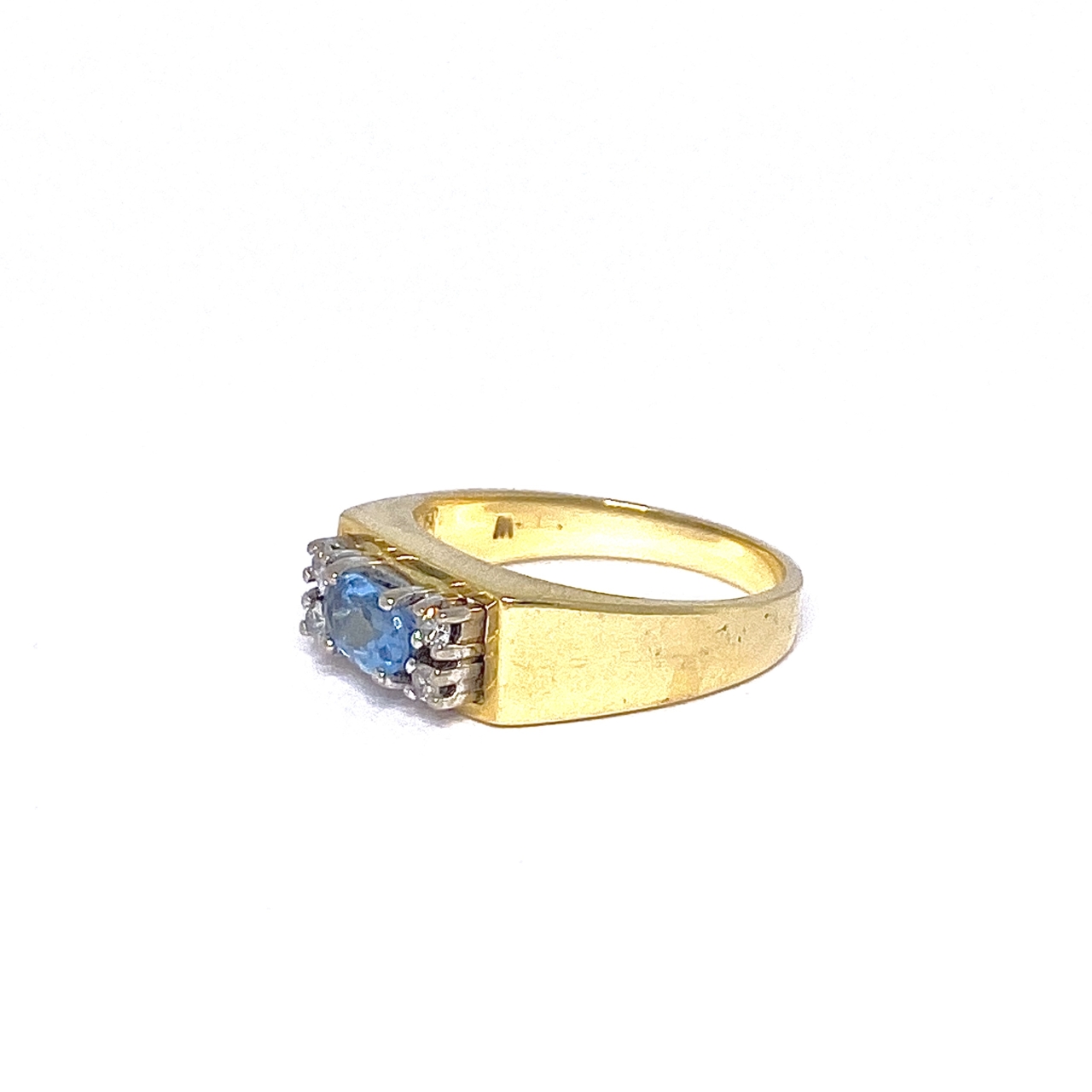 Blue cabochon cut solitaire Aquamarine with diamond accents set in 18ct gold.