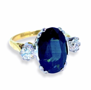 Stunning Vintage 1960's Sapphire and Diamond 3 Stone Ring, mounted in 18ct yellow gold with the diamonds and sapphire set in platinum. This is a beautiful ring, in excellent condition. The Tiffany shank is stamped 18ct & Plat. The sapphire measures approximately 14mm X 9mm and weight approximately 6 carats. Each diamond weights approximately 0.25 carats - total diamond weight = 0.50 carats.