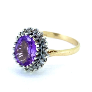 Vintage Amethyst and Diamond oval cluster Ring, Hallmarked 9ct. The Amethyst is claw set and surrounded by claw set faceted diamonds.