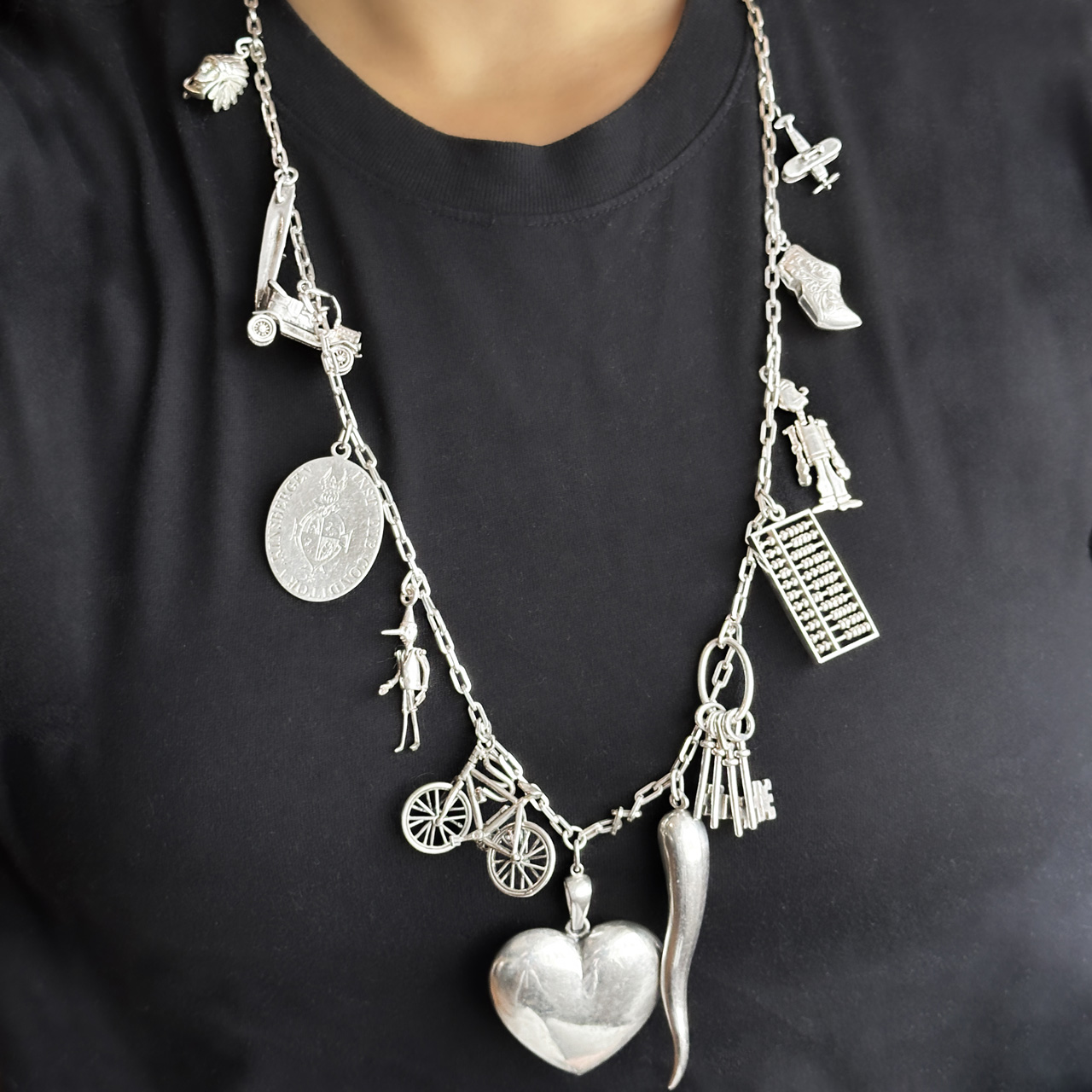 Vintage Silver 13 Charm Long Chain Necklace in neck