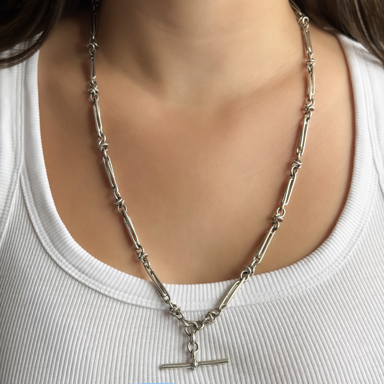 Edwardian 25.5" stylised knot & trombone link Albert chain silver on neck