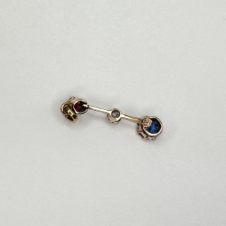 Exquisite fine Edwardian three stone gem pendant with colours red, white and blue. The pendant is set in a 15ct yellow gold. The ruby on top followed by a smaller brilliant cut antique diamond, the sapphire to the bottom of the pendant. The gems have claw settings. The drop including the bale is 2.5cm. 