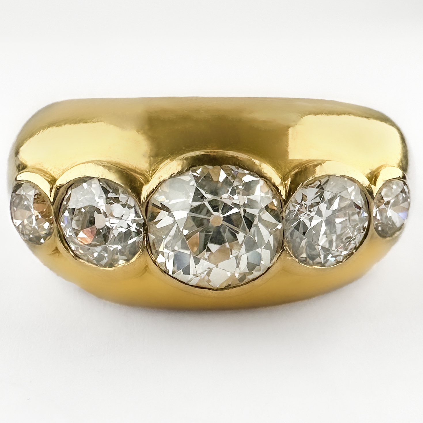 Stunning 1950's 5 Stone Diamond Ring 2.15ct. The amazing ring features 5 graduating round transitional Edwardian diamonds rub over set in 18ct yellow gold. The central diamond is 1.20cts, the total diamond weight is 2.15cts. The sparkly diamonds are G in colour and VS2 clarity. The ring is chunky and robust, it would look great as part of a stack or as a statement piece. Please contact us if you would like to know more about this incredible ring or visit us at Saddingtons Jewellery, Mayfair.