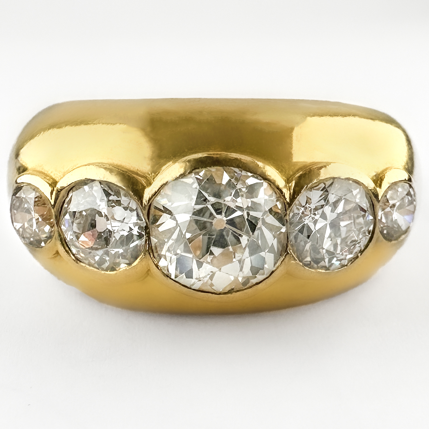 Stunning 1950's 5 Stone Diamond Ring 2.15ct. The amazing ring features 5 graduating round transitional Edwardian diamonds rub over set in 18ct yellow gold. The central diamond is 1.20cts, the total diamond weight is 2.15cts. The sparkly diamonds are G in colour and VS2 clarity. The ring is chunky and robust, it would look great as part of a stack or as a statement piece. Please contact us if you would like to know more about this incredible ring or visit us at Saddingtons Jewellery, Mayfair.