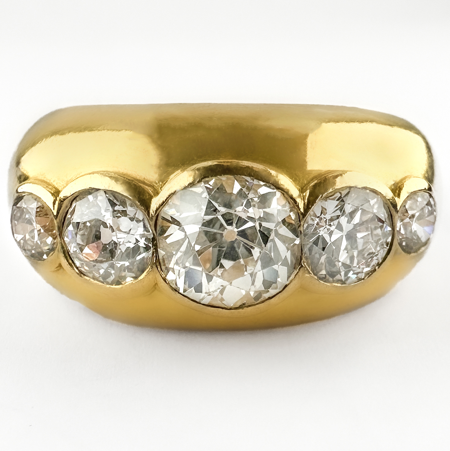 Stunning 1950's 5 Stone Diamond Ring 2.15ct. The amazing ring features 5 graduating round transitional Edwardian diamonds rub over set in 18ct yellow gold. The central diamond is 1.20cts, the total diamond weight is 2.15cts. The sparkly diamonds are G in colour and VS2 clarity. The ring is chunky and robust, it would look great as part of a stack or as a statement piece. Please contact us if you would like to know more about this incredible ring or visit us at Saddingtons Jewellery, Mayfair.