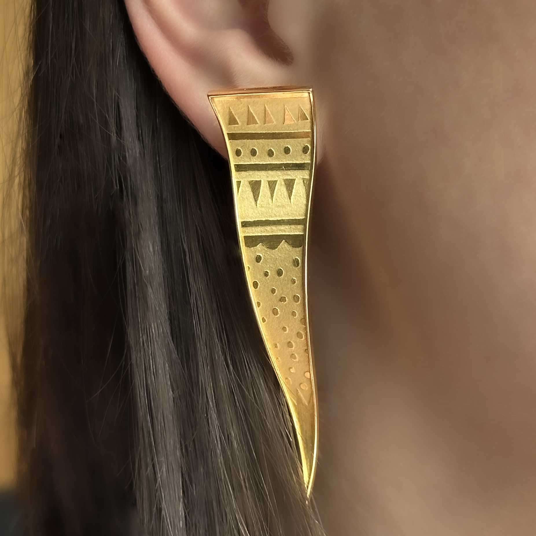 Stylistic 1980's Abstract Gold Tapered Drop Earrings. These very wearable designer long drop earrings features a softly undulating waved silhouette, engraved with geometric motifs including triangles, dots and linear bands. The gentle wave adds movement and fluidity, while the textured finish contrasts beautifully with the polished edges. Made from beautiful stamped 18ct gold. Lightweight yet impactful, these earrings frame the face with a long, sculptural line, giving modern and effortless elegance. The earrings measures 2.5 inches long with the top being 0.6 inches wide tapering to a point. The earrings have a post and butterfly fitting on the back. Please contact us if you would like to know more about these wonderful earrings or visit us at Saddingtons Jewellery, Mayfair.