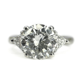 GIA Certificated 1.40ct Diamond Solitaire Platinum Ring With Triangular Cut Diamond Shoulders.The beautiful and bright natural central diamond 1.40ct has a GIA certificate report 2527365195 is set with triangular cut diamond shoulders.The central diamond measures 0.6mm diameter,the entire head of the ring including the shoulder diamonds 1.4mm.This ring sits low and comfortable on the finger and can be resized.Please contact us if you would like further information on this stunning ring.
