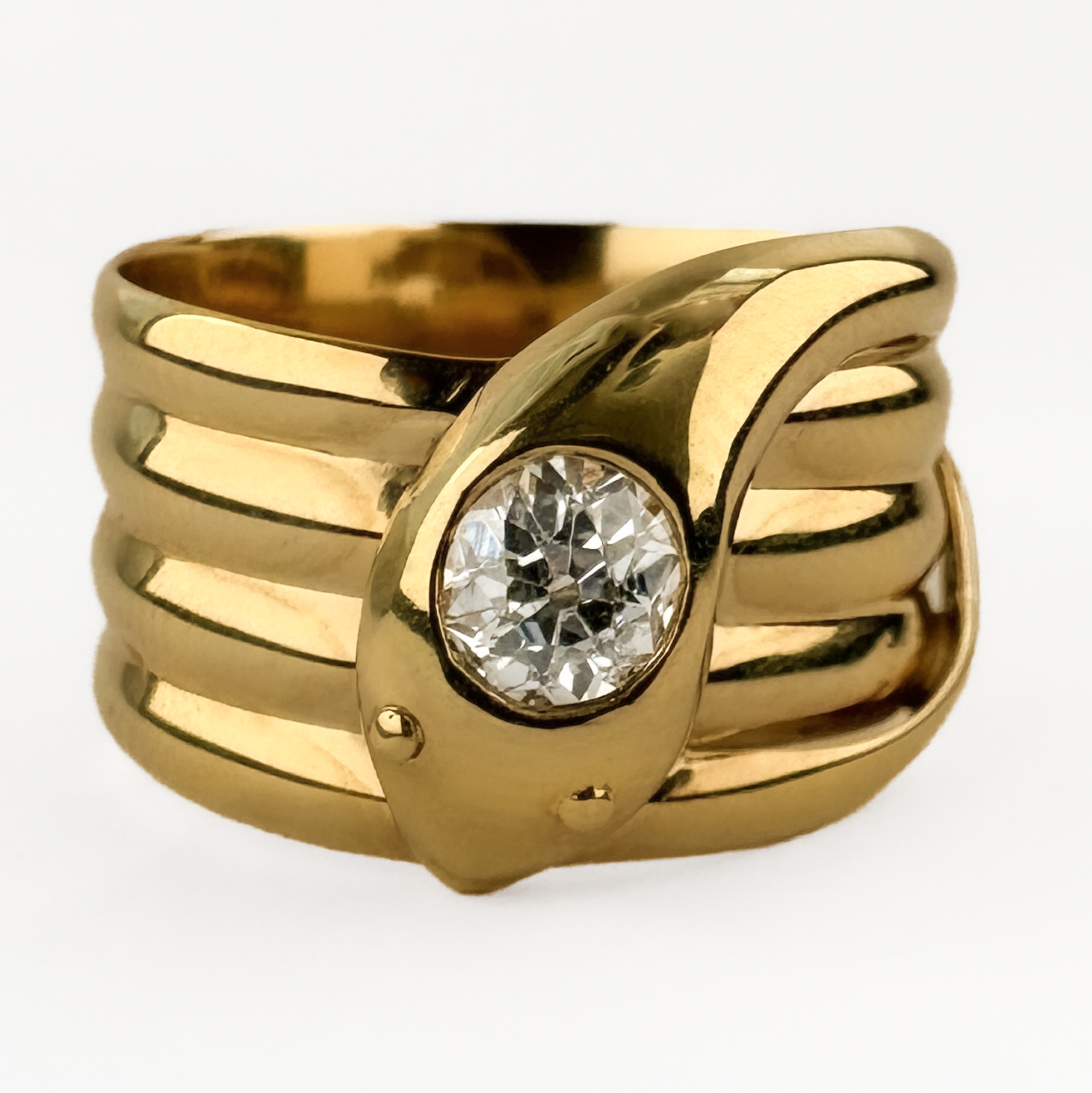 Stunning Old Cut Diamond Coiled Snake Ring. This antique ring is crafted from 9ct yellow gold and features a elegant coiled design rising to a central snake head set with a striking 0.55ct old cut Victorian diamond. The snake wrap motif was very popular in late Victorian and Edwardian jewellery, symbolising eternity and strength. The ring features a Chester hallmark and is dated to 1909. This ring combines sculptural design with romantic brilliance from the bring diamond. The diamond is G-H in colour and VS clarity. Please contact us if you would like to know more about this beautiful ring or visit us at Saddingtons Jewellery, Mayfair.
