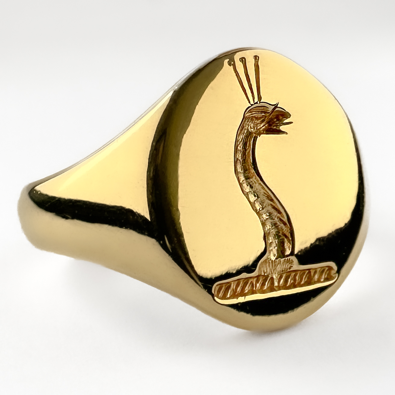 Vintage Sea Serpent Intaglio Signet Ring. The ring is designed with a classic oval signet head, highly polished and engraved with a stylised serpent in a flowing, dynamic form. The motif evokes a sense of strength and mythology, offering a distinctive alternative to traditional crest engravings. Substantial and well-made, the ring has a smooth, weighty feel and a clean, timeless profile that makes it both striking and highly wearable. The signet also features a Birmingham hallmark dating the ring to 1994. It weighs 10.4g and can be resized. Please contact us if you would like to know more about this lovely signet ring or visit us at Saddingtons Jewellery, Mayfair.