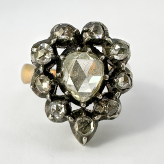 Exquisite Victorian Antique Rose Cut Diamond Cluster Ring. Central 0.5ct pear shaped rose cut diamond with a 0.45ct total weight of 9 hugging rose cut surrounding forming a heart shape. The ring has the outstanding and unmistakable candlelight shimmer and glow from the beautiful rose cut diamonds. The diamonds are cut down set. The ring has a later shank in 18ct warm rose gold giving strength and wearability to this extraordinary ring while retaining its original period charm. The head of the ring measures 1.8cm x 1.5cm. Typical of the era, the ring lays flat and comfortable on the finger. Please contact us if you would like to know more about this ring. It is available to view Saddingtons Jewellery, Mayfair.