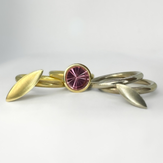 Stunning Collection of Louise O'neill 4 Tourmaline Stacking Rings. There are a set of 4 individual rings by designer Louise O'neill, 2 in yellow 18ct gold, one of these has an abstract rubover set circular pink tourmaline. The 18ct white gold rings, one is a band the other has an abstract long oval shape. They all form an exquisite stacking statement ring. The rings have the Louise O'neill makers mark in addition to the hallmark, London 2008. The collection is beautiful on the finger. Please contact us if you would like to know more about this unique set of rings or visit at Saddingtons Jewellery, Mayfair.