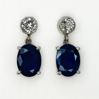 1ct Sapphire and Diamond Drop Earrings. Beautiful oval claw set midnight blue natural sapphire drops, the top of the earring is rub over milgrain edge set old cut diamond. The mount is 18ct white gold with a post and butterfly setting. The earrings sit comfortably on the ear and move gently when worn with a sparkling shimmer. Please contact us if you would like to know more about the earrings or visit us at Saddingtons Jewellery, Mayfair.