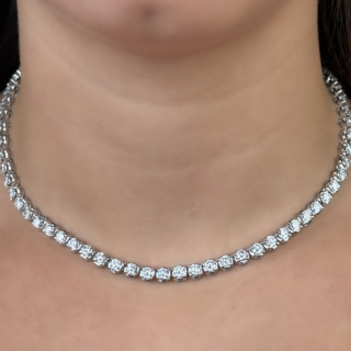 Luxurious 17.40ct Diamond Line Necklace.Striking line/tennis necklace measuring 15.5 inches long in 18ct white gold.The necklace is articulated with 67 claw set full cut round brilliant diamonds.Each diamond weighs 0.26 ctw totalling 17.4ctw.Colour F-G,Clarity VS1.At the centre of the necklace there is a jump ring that hinges down to enable the necklace  to have a pendant added.A beautiful bright and sparkling diamond necklace.The securing clasp in a snap plate with side securing clip.The diamond total carat weight and '750' is marked on the bottom of the snap plate.Please contact us if you would like to know more about this necklace.
