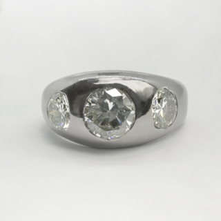 Large Platinum 2ct Diamond 3 Stone Gypsy Ring.This is a substantial statement gypsy ring with 3 bright brilliant cut diamonds. The central diamond is 0.95ct weight of diamond with two 0.55ct weight of diamond, one each side of the central stone.The diamonds are gypsy set in polished platinum which has a light patina,the Birmingham hallmark is inside the shank of the ring.The ring is a large size UK,W1/2.It can be resized.Please contact us if you would like to know more about this unusual stunning ring.