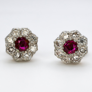 Stunning Ruby & Diamond Cluster Stud Earrings.Central Burma rubies surrounded by eight bright brilliant cut diamonds in a typical 'flowerhead' style.The gallery, posts and butterfly securing fixings are all 18ct yellow gold.Comfortable to wear.Please contact us if you would like to know more about these beautiful earrings.