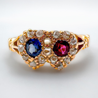 Beautiful Victorian Sapphire & Ruby Double Heart Ring.A sweet and authentic dainty 18ct yellow gold ring with a carved shank with a 1900 Birmingham hallmark.The central gems are pave set,there is a round velvet blue Ceylon sapphire and a glowing Burma ruby next to each other each with a 'heart' border of pave set old cut diamonds displaying a linked double heart.The ring is UK size L1/2 and can be resized preserving the hallmark.Please contact us if you would like to know more about this ring.