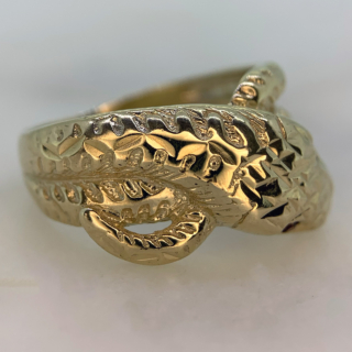 Beautiful Vintage Ruby Set and Diamond Cut Snake Ring in Hallmarked 9ct yellow Gold, Birmingham. The ring is embellished with two red ruby eyes measuring approximately 1.2 mm in diameter. The front of the shank is decorated with diamond cut detail to replicate a snakes scales, the shank tapers to the back where it is smooth polished. The width of the band is approximately 12.5 mm at the head and 2.5 mm at the back. These rings were extremely popular in the victorian era as they are a symbol of eternal love, this vintage retake of the ring is in excellent condition.