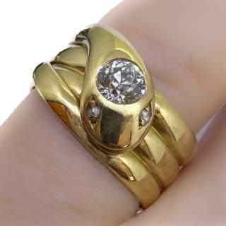 Rare Chester Hallmarked Antique Snake Ring Old Cut Diamond Head.Dated 1899,3 coils on the body with the snake head dropping over the front of the ring.The ring is 18ct yellow gold with a stunning old cut diamond on the snakes head, known diamond weight 0.52cts of diamond.The snake additionally has old cut diamond eyes.The width of the ring at the widest is 1cm.If you would like to know more about this ring please contact us.