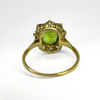 A Victorian Delicious Peridot & Old Cut Diamond Cluster Ring.Central faceted glowing olive green peridot with mid and dark green hues,measures 0.8mm diameter.The mesmerising peridot is surrounded by 10 beautiful old cut diamonds.The gems are claw set in 18ct yellow gold with an 18 ct yellow gold shank,the gallery has a pierced pattern.The head of the ring measures 1.4cm diameter.The cluster ring sits low on the finger and is comfortable to wear.Please contact us if you would like more information about this ring.This ring can be resized