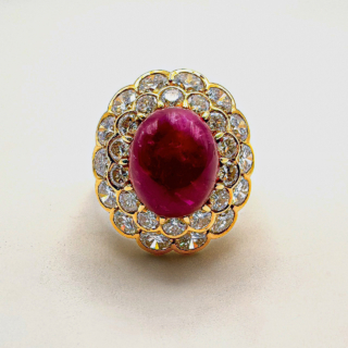 Stunning Statement Large Cabochon Ruby Diamond Cluster Ring.The central large oval 6+.ct ruby has a rich and luxurious colour and is surrounded by bright brilliant cut diamond cluster.The shank is substantial in size and is 18ct yellow gold.An exquisite and beautiful ring that sits comfortable on the finger.Please contact us if you would like more information on this beautiful ring