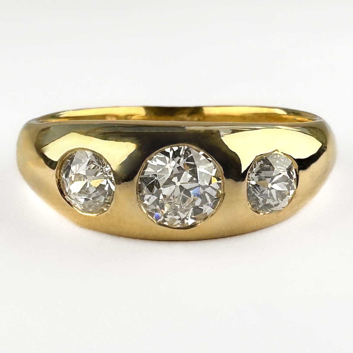 Stunning 3 Stone Diamond Gypsy Ring. This amazing gypsy ring features 3 bight Victorian brilliant old cut diamonds, H-I in colour and VS2 clarity. The diamonds weight totals to 1ct. The diamonds are all gypsy rub over set in an 18ct yellow gold shank. The shank features the remains of a hall mark with an H stamp. The ring dates back to the early Edwardian late Victorian era. This ring is a really great quality and sits comfortably on the finger. Please contact us if you would like to know more about this beautiful ring or visit us at Saddingtons Jewellery, Mayfair.