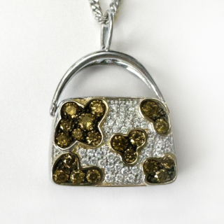 Designer Iliana Cognac Diamond Handbag Necklace.18ct white gold Handbag/Purse pendant with makers mark 'M' ,18ct with trademark diamond above.Beautiful sparkling and bright pave set cognac and white diamonds in attractive cluster patterns.The handbag measures 1.8 x 2.2cm which includes the bale.The bag has the makers mark Iliana on the base of the bag with 'JC' & '750'.The pendant is sold on its own but a chain can be sold separately.Please message us if you would like to know more about this pendan