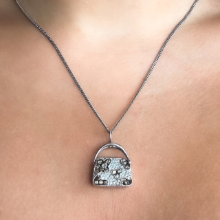 Designer Iliana Cognac Diamond Handbag Necklace.18ct white gold Handbag/Purse pendant with makers mark 'M' ,18ct with trademark diamond above.Beautiful sparkling and bright pave set cognac and white diamonds in attractive cluster patterns.The handbag measures 1.8 x 2.2cm which includes the bale.The bag has the makers mark Iliana on the base of the bag with 'JC' & '750'.The pendant is sold on its own but a chain can be sold separately.Please message us if you would like to know more about this pendan