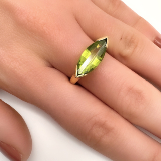 Vibrant Peridot Diamond Marquise Ring.Unusual and striking vintage Peridot ring which is the main stone.There are diamonds set in the gallery of the ring which has scrolls also.A really well designed ring in 18 ct yellow gold.If you would like to know more about this ring please message us.