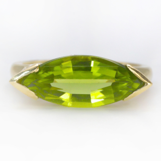 Vibrant Peridot Diamond Marquise Ring.Unusual and striking vintage Peridot ring which is the main stone.There are diamonds set in the gallery of the ring which has scrolls also.A really well designed ring in 18 ct yellow gold.If you would like to know more about this ring please message us.