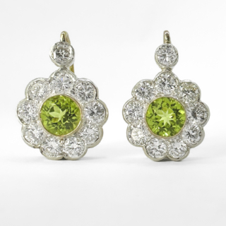1940's Peridot Diamond Cluster Earrings. Beautiful and sparkling cluster earrings. 18ct yellow and white gold. The clusters earrings have French ear wires with safety clips to secure on the ear. The peridots measure 6mm in diameter, 1ct diamond weight.Each peridot is surrounded by 9 brilliant cut diamonds with one extra diamond at the top of the cluster. The total diamond weight for one earring is 1.10cts, the diameter of each earring is 13mm. The earrings are boxed. Please contact us if you would like to know more about these earrings.