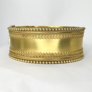Rare Oval Large Victorian Etruscan 15ct Cuff Bangle. This beautiful hinged bangle is 15ct yellow buttery glowing gold. the front of the bangle has an area of plain unpatterned gold with  raised scrolling to the inside edge of the central area with borders of small rope design, the outer edge of the bangle has a continual ball design. The back of the bangle is plain as the middle of the front bangle. The width of the bangle is 2.4 cm, The diameter 5.7 x 4.7 cm. The bangle is hinged, perfect condition with a wide snap plate and additional figure of 8 security clasp. The bangle is presented in its original box. The gold finish is original and has a beautiful glowing patina. Please contact us if you would like to know more about this bangle or visit us at Saddingtons Jewellery, Mayfair.